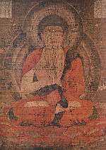 Frontal view of a cross-legged deity.