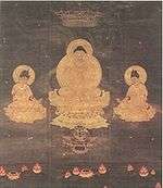 Frontal view of a deity seated on a pedestal framed by two seated attendants.