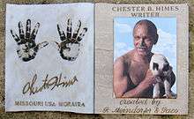 Left panel shows two hand prints, handwritten name Chester Himes, and block text "Missouri USA, Moraira." Right panel shows bust of muscular shirtless man with little hair, graying mustache, bare chest, dark skin, holding siamese cat. Italic text is "created by R. Mendorfer & Paco."