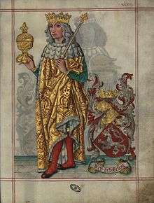 A crowned man holding a royal sceptre