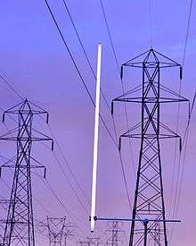 Capacitive coupling with high-voltage power lines can light a lamp continuously at low intensity.