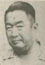 An older Chinese man looking at the camera