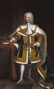 George with his hand on an orb