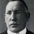 A black-and-white picture of a man with a moustache.