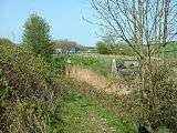 Lancaster Canal and M6 motorway, near Tewitfield. This scruffy photo shows the even more scruffy second termination of the open canal, which disappears into a culvert for 150 yard under the road.