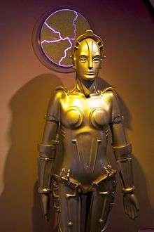 A replica of a gold-plated feminine robot.