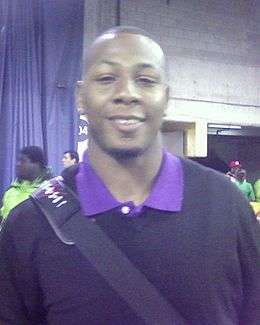 An American football player wearing a baby blue jersey with the number 81 across the chest and black cap on his head