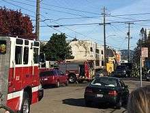 A block with a burned out warehouse and a fire truck