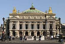 The Opera House in Paris is an ornate 19th century building decorated with much sculptured detail.