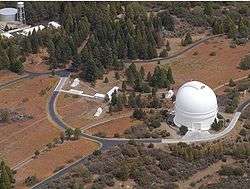 PTI is located atop Palomar Mountain, next to the large white dome of the historic 5 m Hale Telescope.