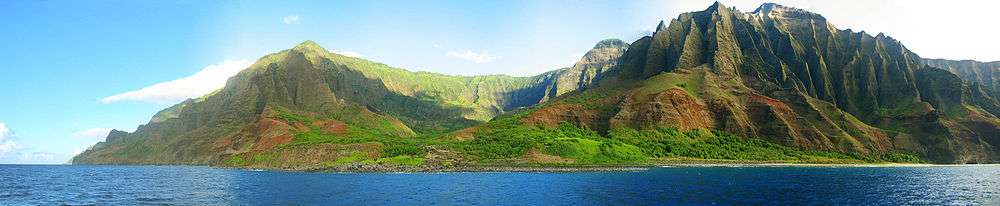 view of the Nā Pali coastline from the ocean. It is part of the Nā Pali Coast State Park which encompasses 6,175 acres (20 km2) of land and is located on the northwest side of Kauaʻii.
