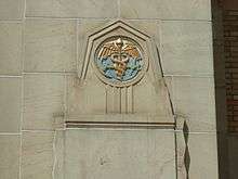 An anchor and caduceus on the exterior of a building