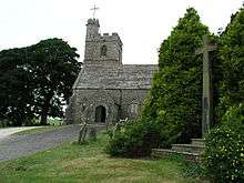 Part of a church with a tower and a higher stair turret, both battlemented