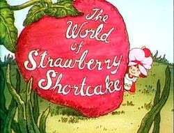 A six-year-old girl, dressed in a pinafore and wearing a pink dust cap on top of her hair, looks out to the right of a giant strawberry. On the strawberry, the words "The World of Strawberry Shortcake" are written in cursive.